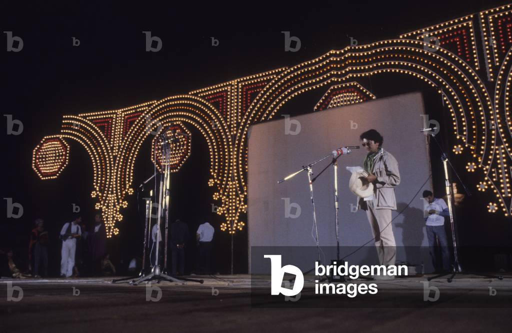 Rome, Piazza di Siena, 1980. Second Festival of the Poets. Italian poet Dario Bellezza during a reading (photo)