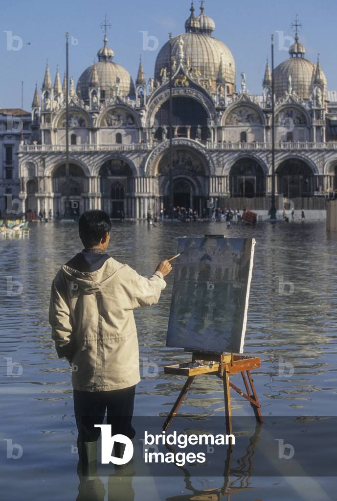 Venice, 1998. High Tide in St. Mark's Square. Man painting in the water