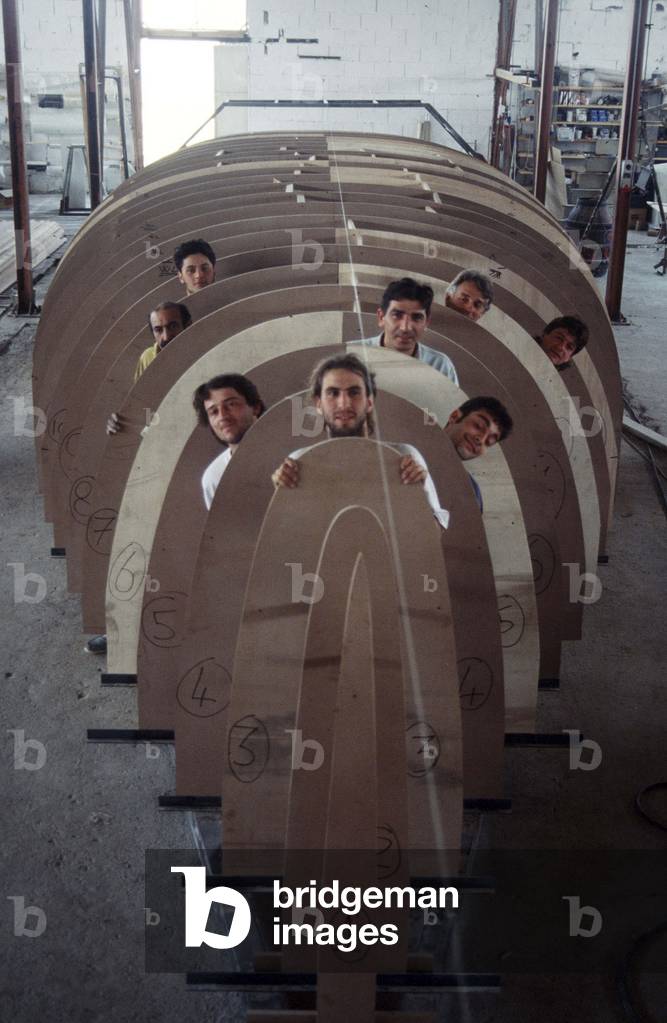 May 1993. Italian sailor Giovanni Soldini (first from the left) in the Toxic Boat shipyards, inside the under contruction hull of his boat to sail solo around the world, built by former drug addicts of the Saman Community with him in the photo (photo)