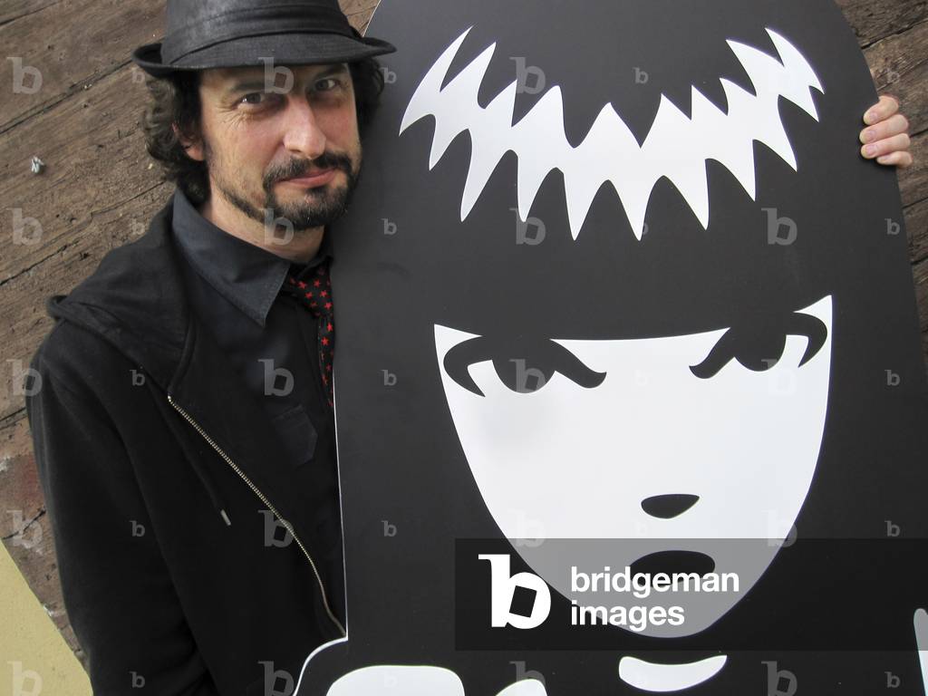 Milan May 3, 2011. American cartoonist Rob Reger posing next to a cutout of his character Emily the Strange