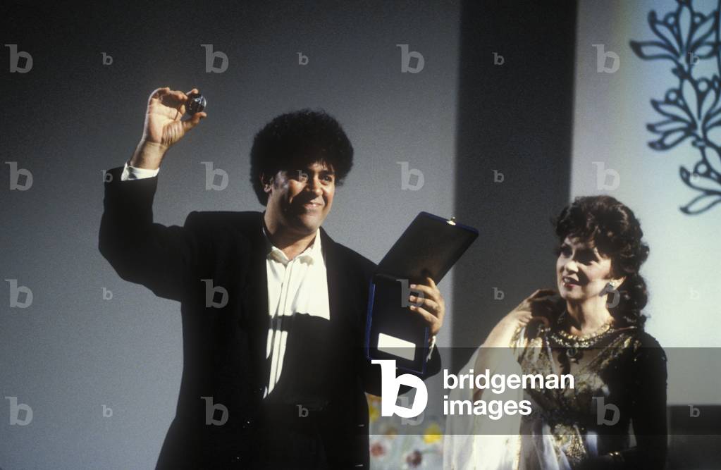 Director Pedro Almodovar receiving from actress Gina Lollobrigida the best script award for his movie 