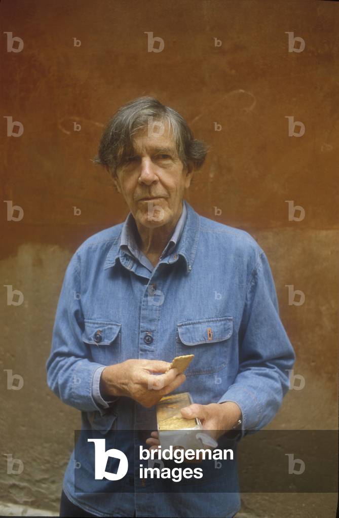 Venice, 1982. American composer John Cage holding a box of cookies for his macrobiotic diet (photo)