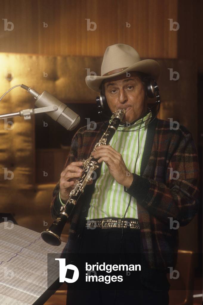 Rome, 1985. Italian TV presenter and showman Renzo Arbore playing the clarinet in a recording studio (photo)