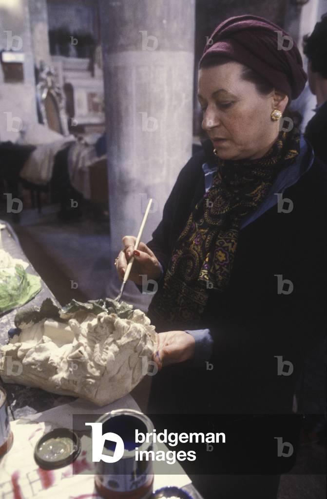 Venice Carnival 1980. Italian set and costume designer Giulia Mfai teaching at her workshop about makeup and disguise in the San Samuele Church