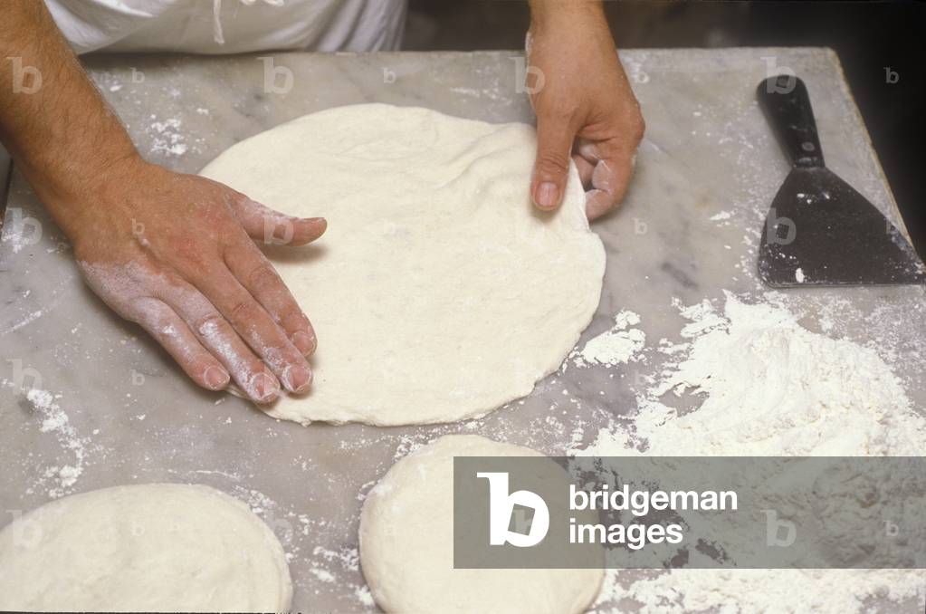 Naples, Italy. Preparation of Pizza Margherita at Brandi pizza restaurant, where in 1889 it was invented in honour of Queen Margaret (Margherita) of Savoy. Second step: stretch the crust