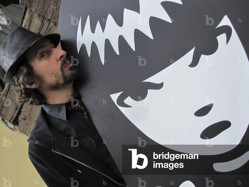 Milan May 3, 2011. American cartoonist Rob Reger posing next to a cutout of his character Emily the Strange (photo)
