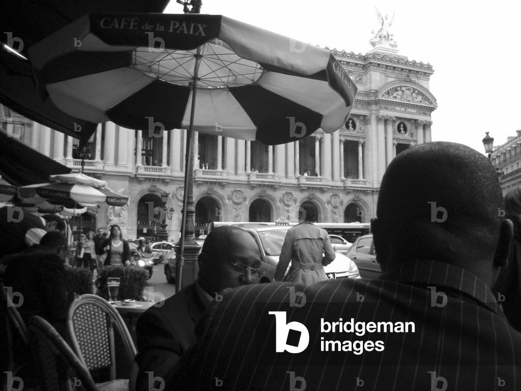 People in the terrace of the Cafe de la Paix in front of the Paris Opera House (Palais Garnier)