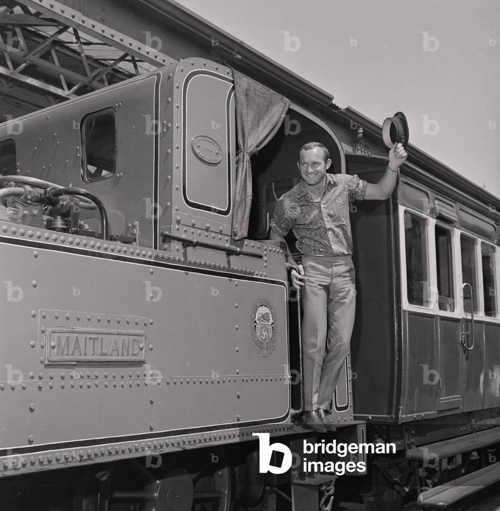 Mike Hailwood on steam train, Isle of Man, June 1967 (b/w photo)
