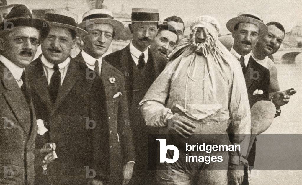 A man wearing an Italian device called an Iarosacco, worn over clothing it enabled the wearer to pass over most streams with the aid of a light oar, from 'The Pageant of the Century', published 1934 (b/w photo)