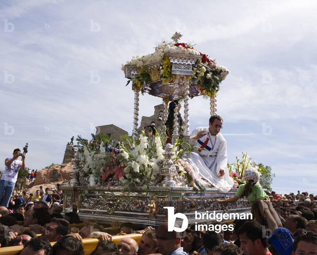 Andujar Jaen Province Spain   Annual Romeria of La Virgen de la Cabeza  Throne with statue of La Virgen and two priests being carried amongst multitude of believers (photo)