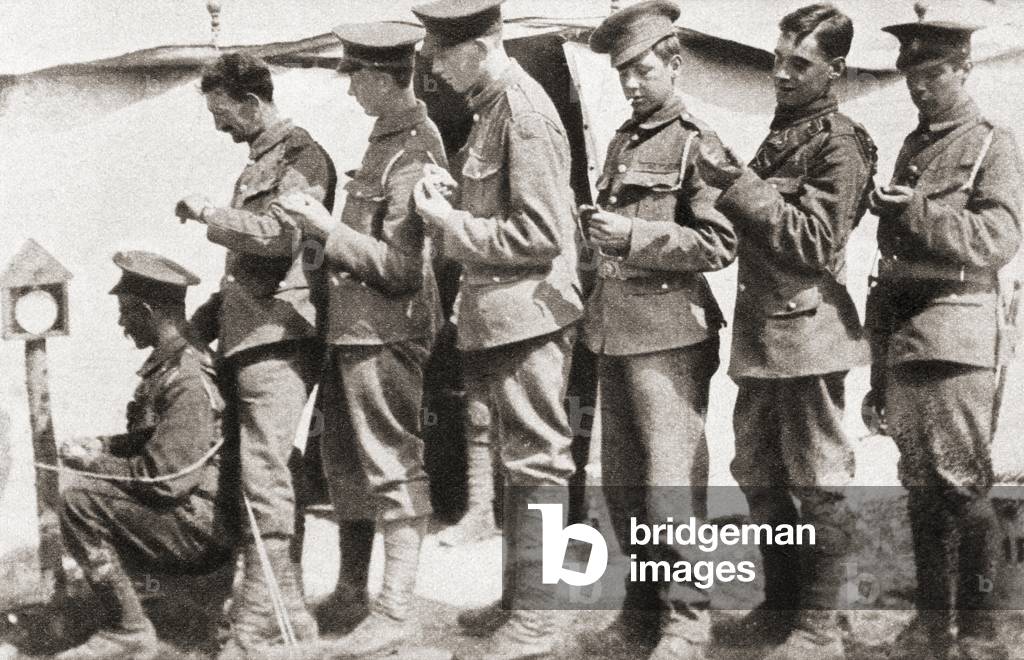 Soldiers during World War One sychronizing their watches with a clock mounted on a post in the camp, from The Pageant of the Century, pub.1934