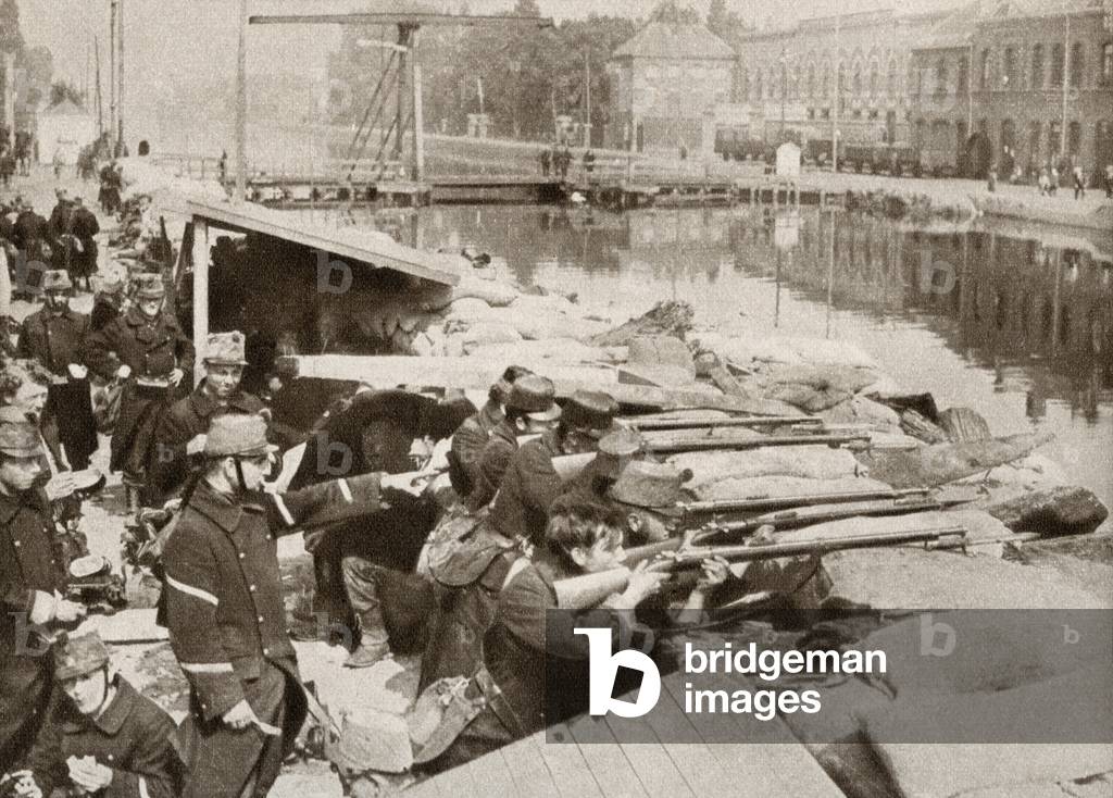Belgian soldiers defending the sandbagged Willebrock Canal from the advancing Germans during WWI, from The Pageant of the Century, pub.1934