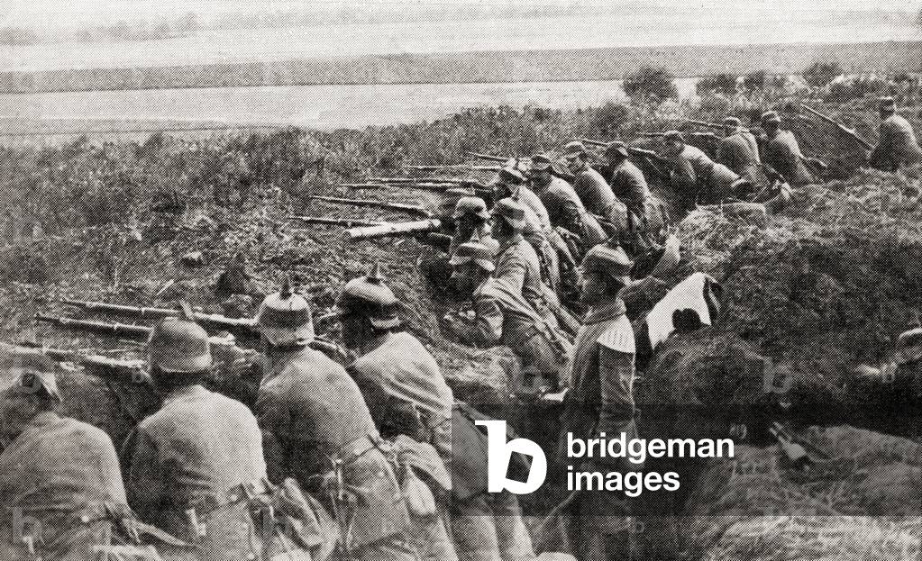 German troops firing from trenches under the direction of an officer during WWI (litho)