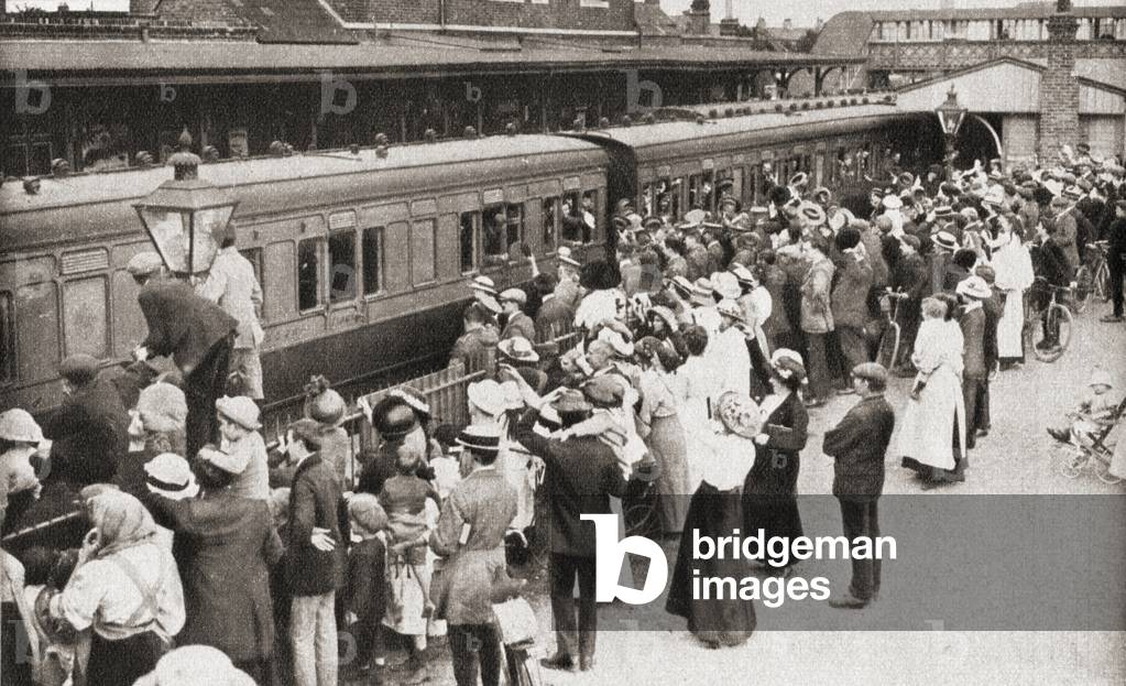 A draft of men board the train in Hounslow, England en route for the front, which in 1914 was Belgium, from The Pageant of the Century, pub.1934