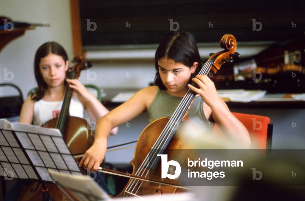 Two girls playing cello