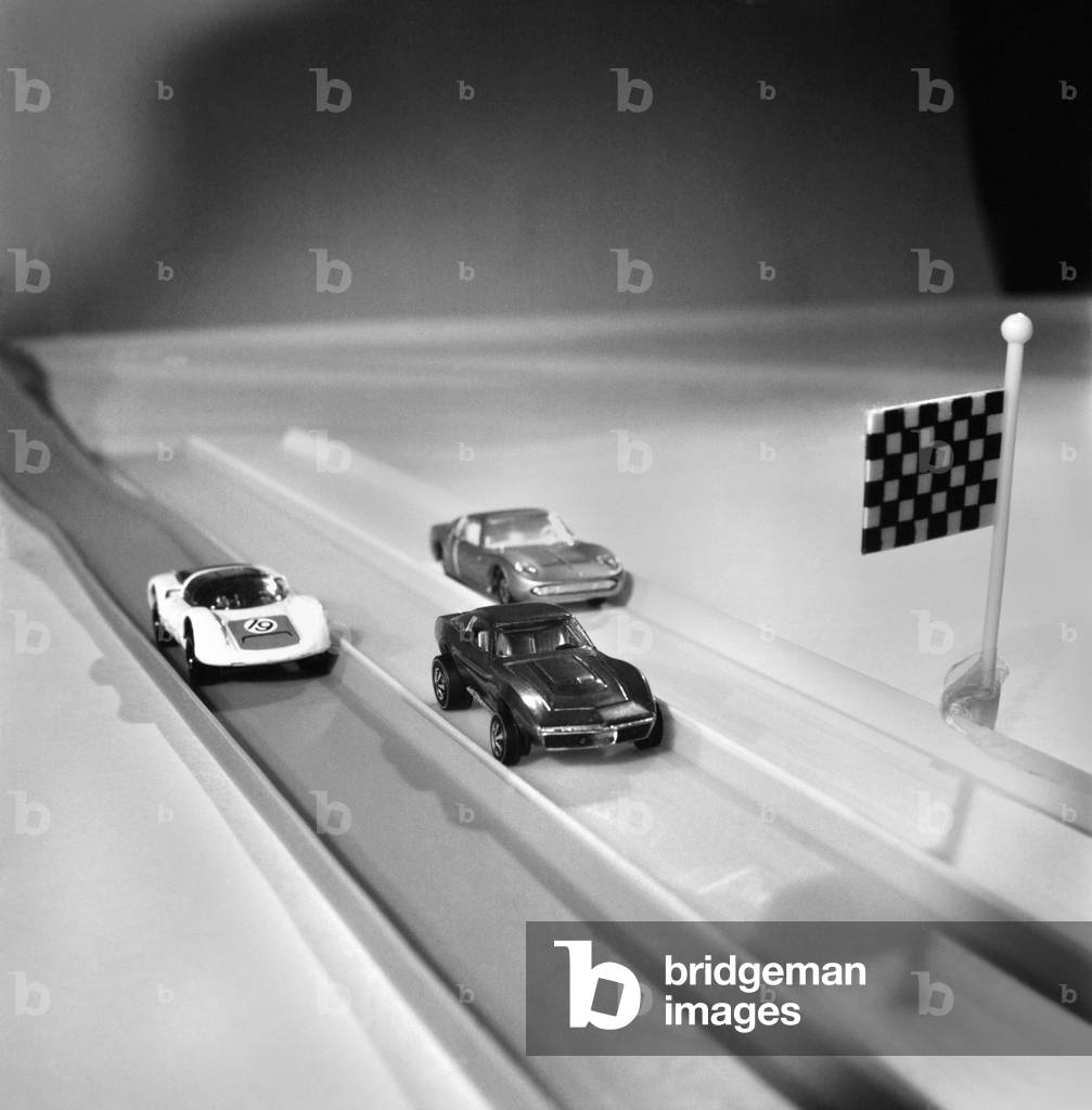 A car racing around a track, part of the Corgi Rockets racing track. 
November 1969