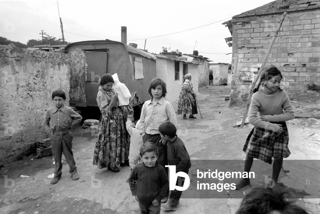 A Mother and children in a poor suburb on the outskirts of Rome, Italy, April 1975 (b/w photo)