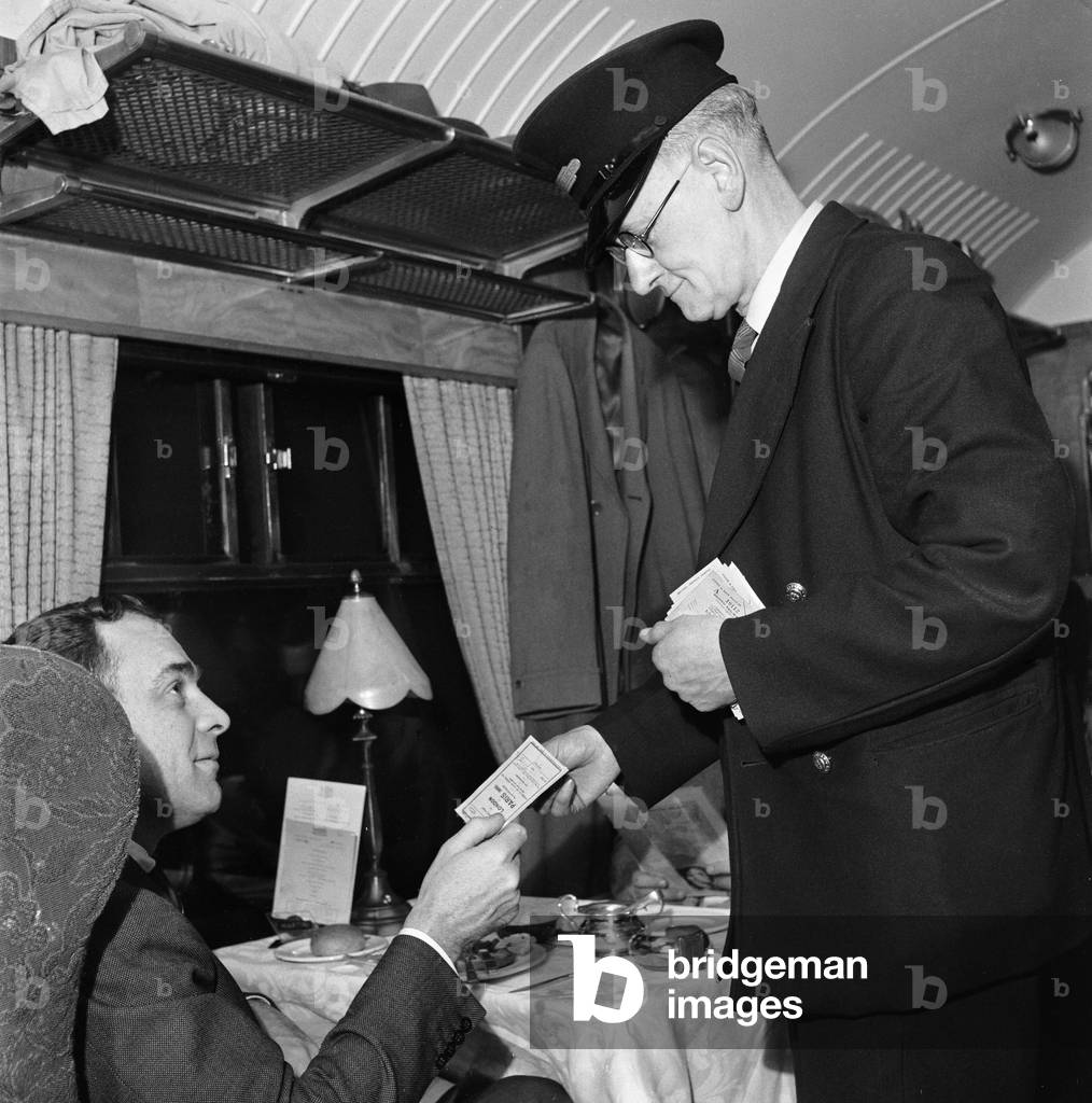 The 'Golden Arrow' Pullman service from London to Paris. Ticket collector Fred Sergeant at work in the Pullman carriage. 5th April 1954 (b/w photo)