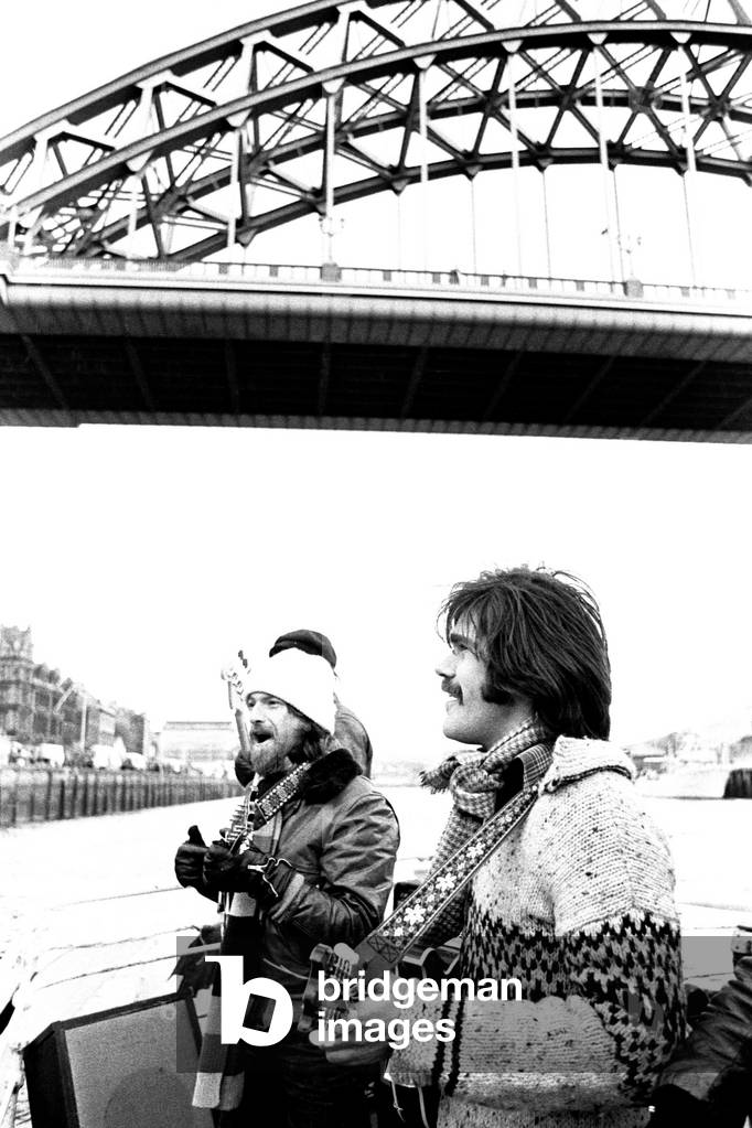Lindisfarne sailed down the Tyne on a musical journey. The group were filming on board a Tyne ferry for a half-hour television show called 'All Right Now'. Si Cowe and Ray Jackson pictured. 4th March, 1979 (b/w photo)