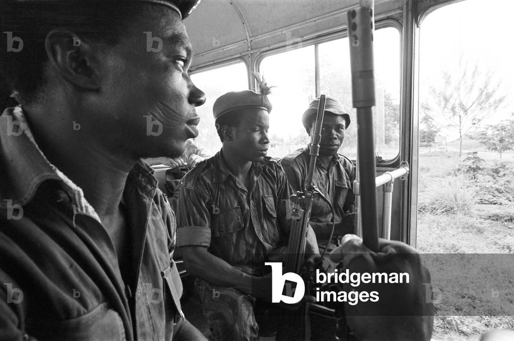 Pictures taken during the Daily Mirror's attempt to reach the refugee camps of Onitsha and Asaba during the Biafra conflict.
A group of soldiers on a bus driving through the camp.
16th July 1968.
