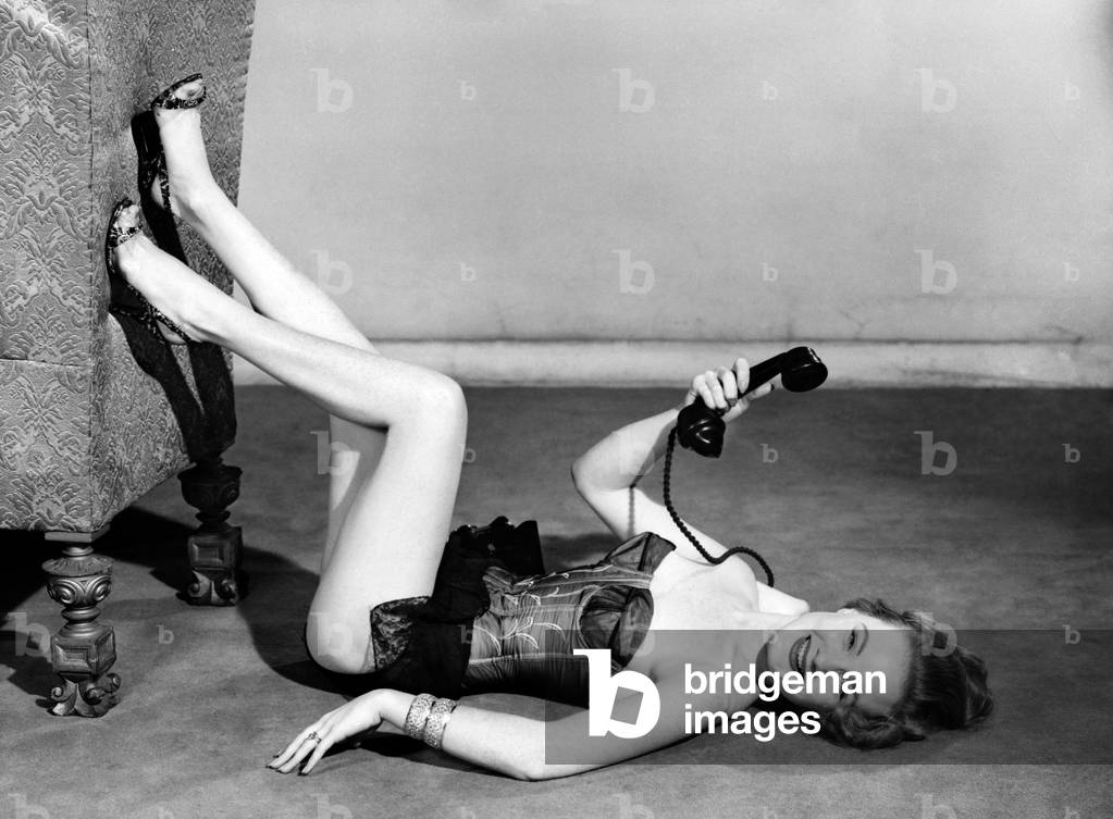 Model wearing underwear on telephone, July 1956 (b/w photo)