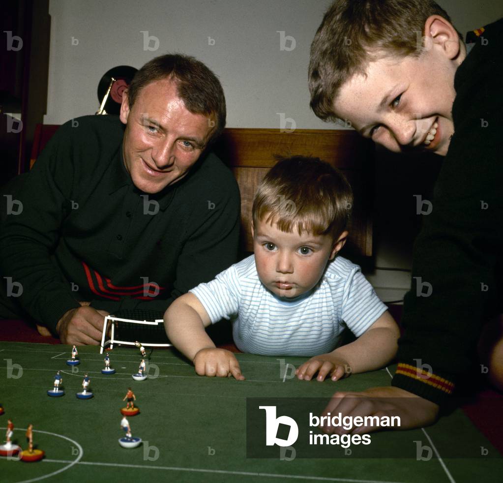 Chelsea manager Tommy Docherty playing Subbuteo at home with his childrenMay 1967 (photo)
