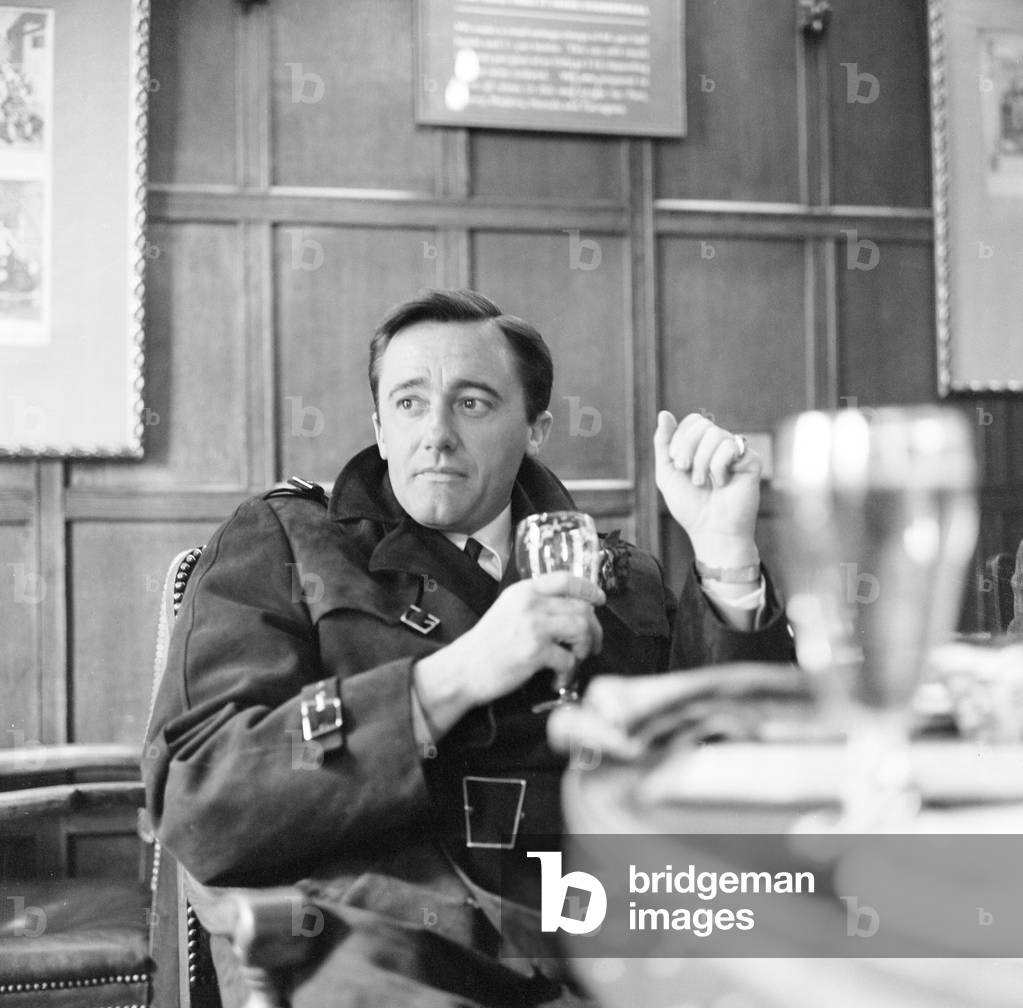 Robert Vaughn, actor who plays the role of secret agent Napoleon Solo in NBC show The Man from U.N.C.L.E., pictured enjoying a quiet drink in a pub on The Strand, London, 22nd March 1966 (b/w photo)