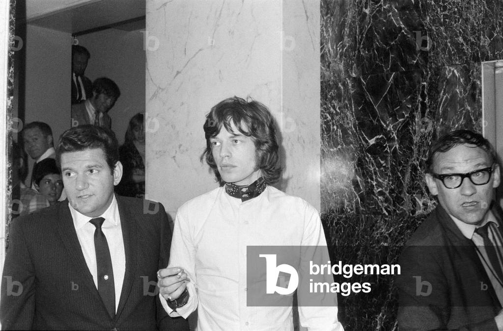 Appeal hearing at the Appeal Court in Central London where Rolling Stones lead singer Mick Jagger and Keith Richards had their convictions and sentence for drug charges set aside by Lord Parker the Lord Chief Justice, Lord Justice Winn and Mr Justice Cusack. Picture shows Mick Jagger arrives for a press conference in Soho after the hearing where he was given a conditional discharge and talking to in place of his three month prison sentence. 31st July 1967 (b/w photo)