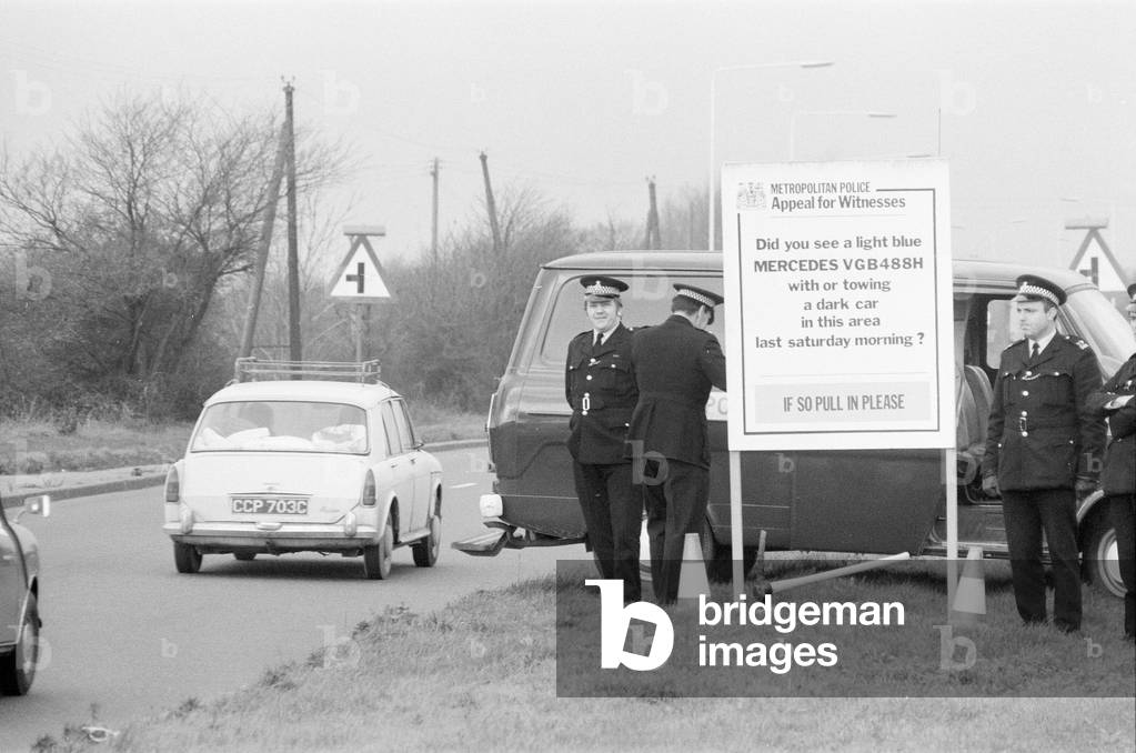 Police road blocks on A127 Southend Road, asking motorists to help with their enquiries into disappearance of haulage contractor George Brett and his son Terry Brett aged 10, who are missing under mysterious circumstances. London. 11th January 1975 (b/w photo)