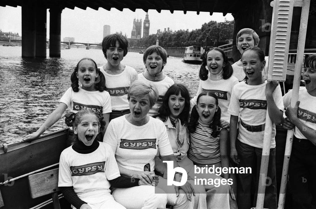The entire cast of the show 'Gypsy' celebrated the, 100th performance by going for a boat trip up the Thames to Kew. The two stars, Angela Lansbury and Zan Charisse, with kids from the show., 2nd September 1973 (b/w photo)