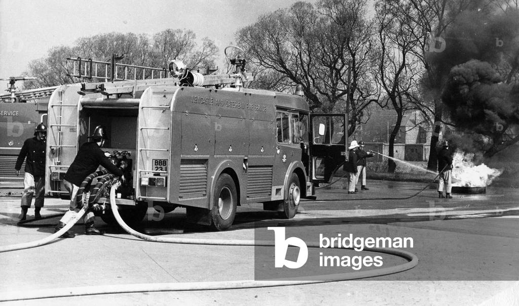 Firefighters in the latest fire engine fight to get a blaze under control, c.1970