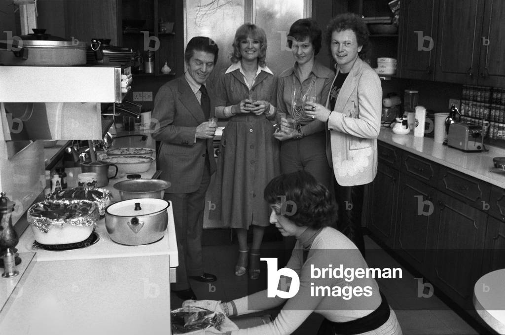 Sonia Allison the Daily Mirror cook is seen here preparing a meal for a invited group of celebrities who include L/R Egan Ronay food critic, Lyn Paul actress, Valerie May and Mike Batt composer, 14th March 1975 (b/w photo)