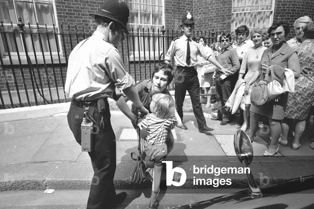 Police move in to arrest Angela Hilary Weight, after she threw red paint over Prime Minister Edward Heath outside Number 10 Downing Street.
25th June 1970