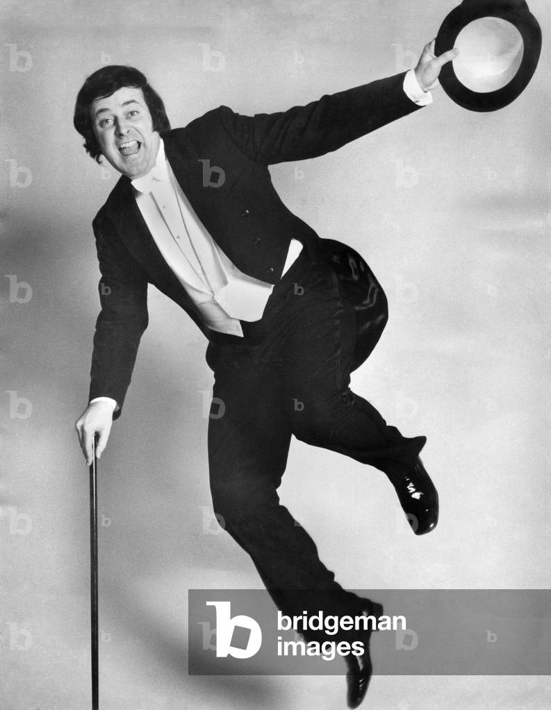 Disc Jockey Terry Wogan in studio looking all dressed up for a night on the town, wearing top hat and tails, December 1972 (b/w photo)