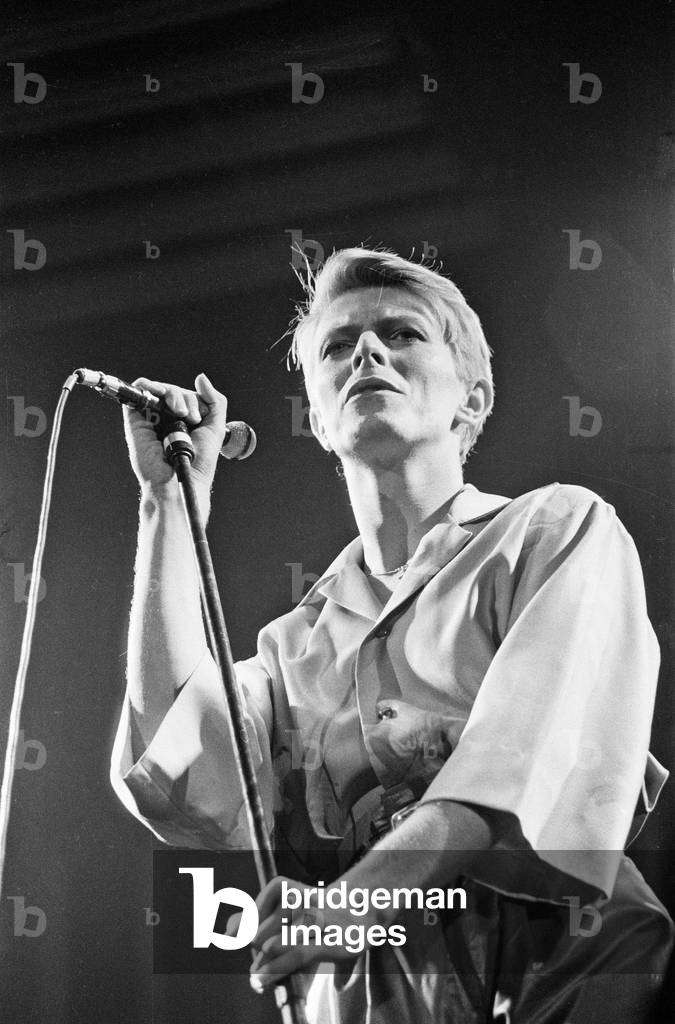 British pop singer David Bowie performing on stage during concert at Wembley, 29th June 1978 (b/w photo)