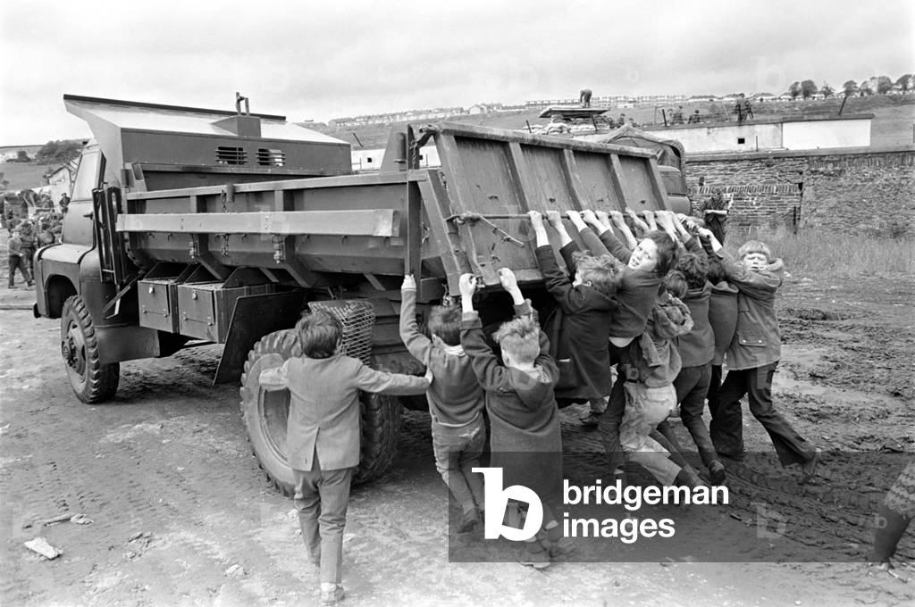Northern Ireland June 1972. Children and soldiers play at the army base on the Foyle Road. The army were in the process of abandoning the camp. June 1972 72-7009-011