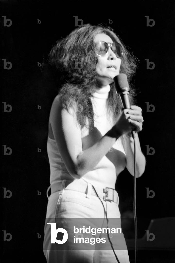 Yoko Ono singing in a charity concert in New York with her husband John Lennon. 
August 1972