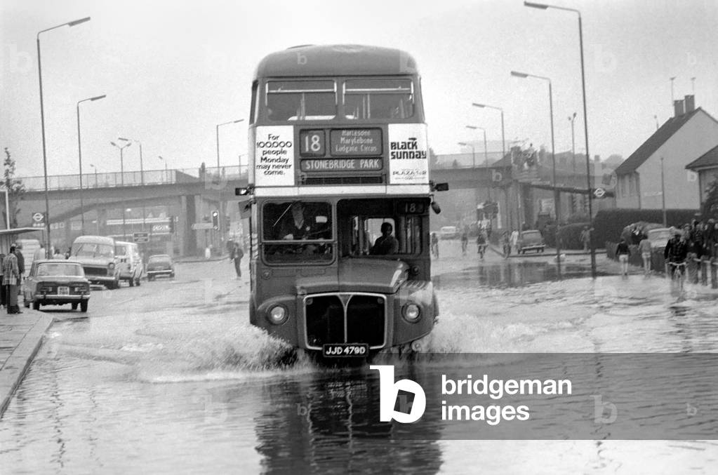 A bus makes its way through a flooded Harrow Road, London, 17/08/1977