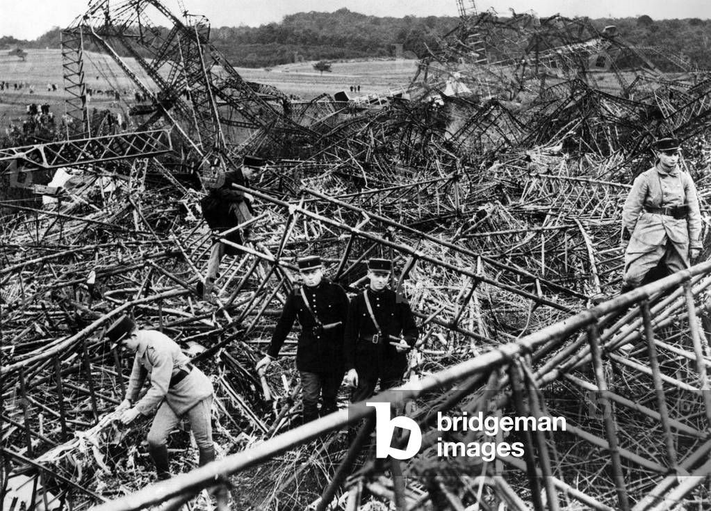 French rescue workers and police amongst the wreckage of the R.101 airship after it crashed near Beauvais, France 
October 1930