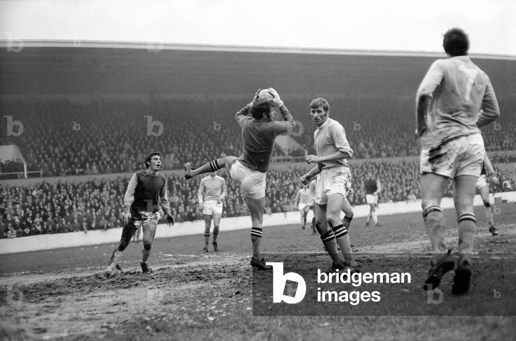 English League Division One match at Upton Park West Ham United v Machester City. City goalkeeper Joe Corrigan gathers the ball watched by defender Tony Book. January 1970 (photo)
