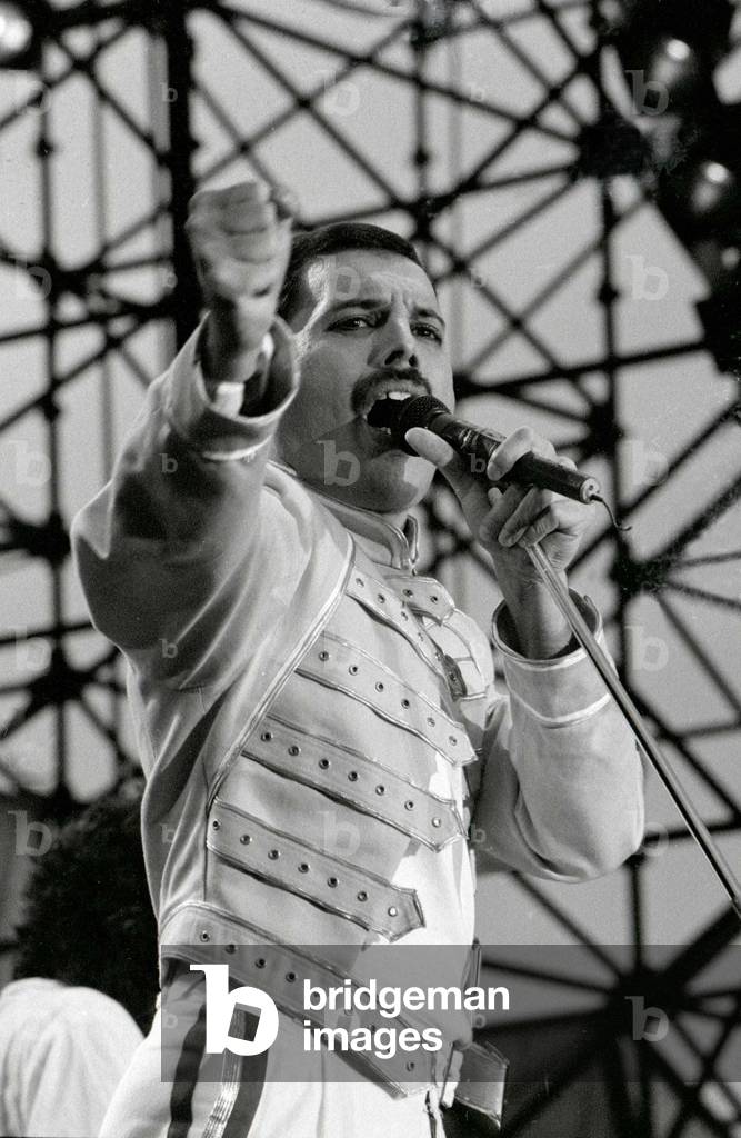 Freddie Mercury of the Rock Group The Queen in concert at St James Park in Newcastle, holding microphone
July 1986