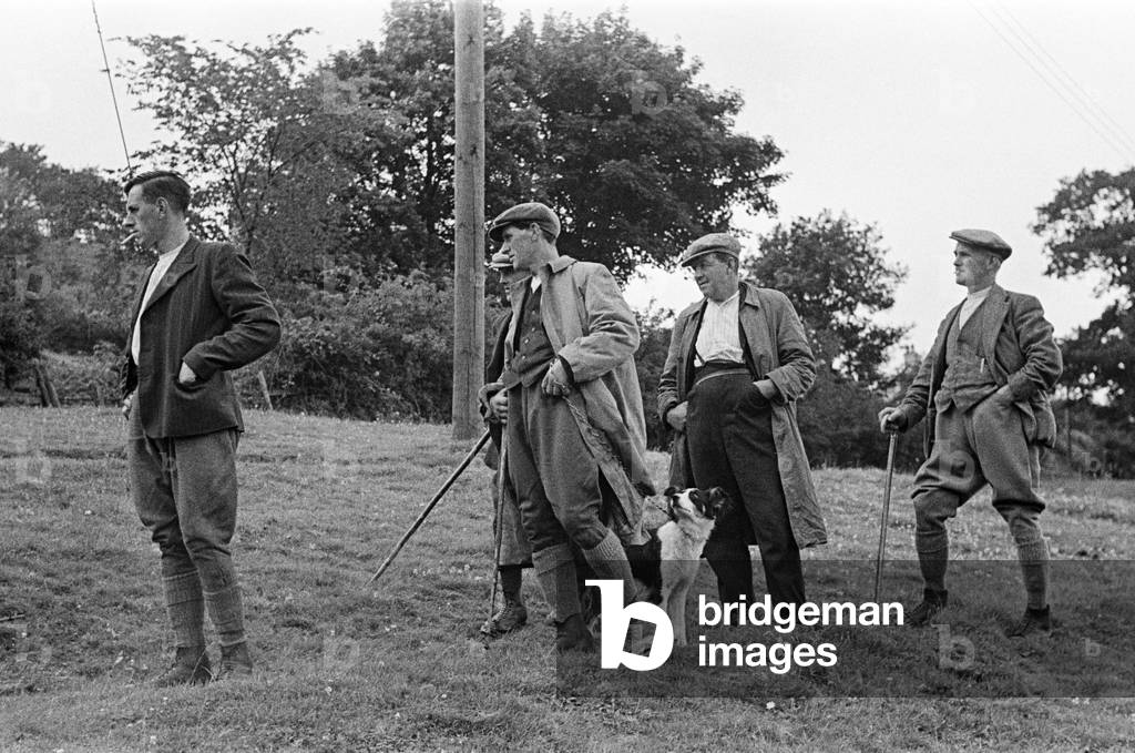 Men gathering to watch sheep shearing in Braithwaite village near Keswick, Cumbria, c. July 1947 (b/w photo)