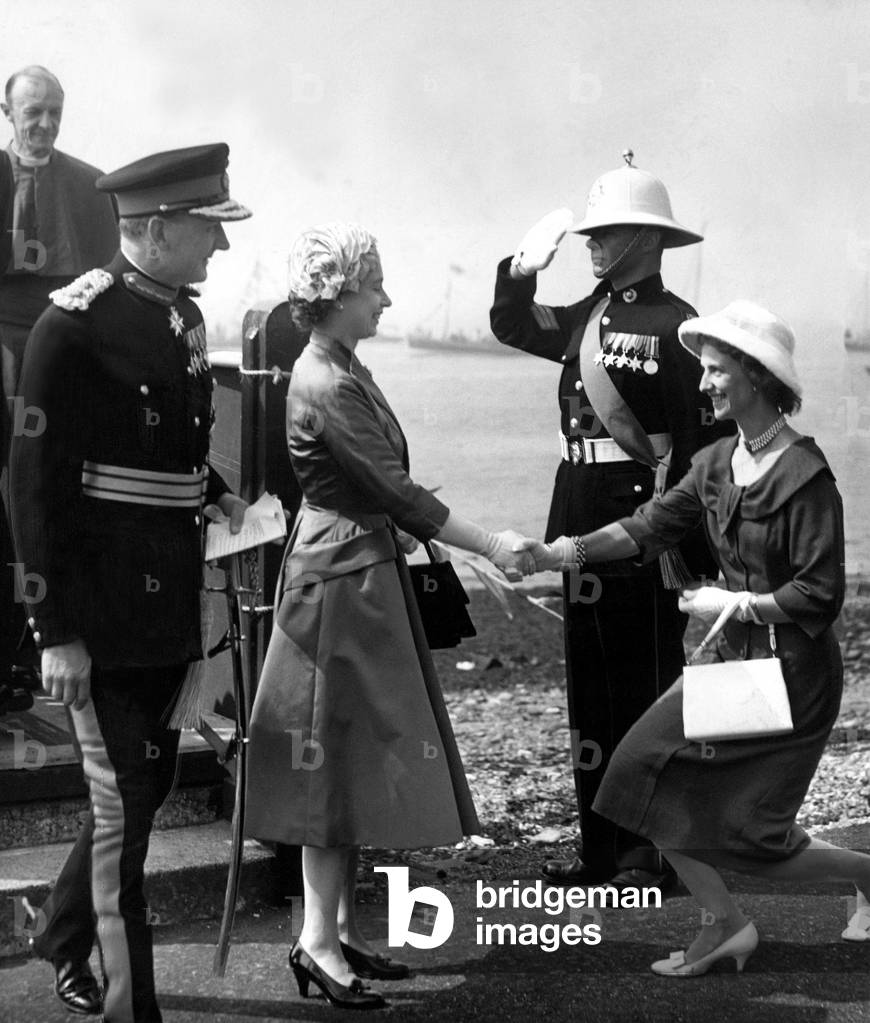 Queen Elizabeth II is introduced to the Duchess of Northumberland during a visit to Holy island, June 1958
