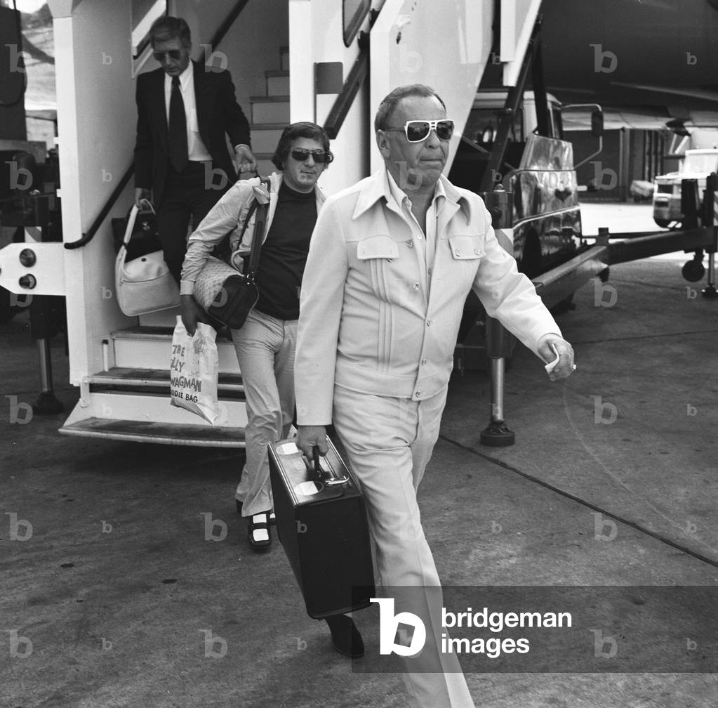 Singer Frank Sinatra seen here arriving from Australia at London Airport 18th July 1974 (b/w photo)