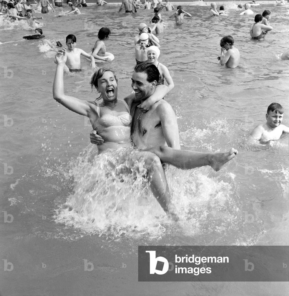 Rhyl bathing pool. Pauline Jones, 23, of Rhyl in the arms of her brother-in-law John Williams of Prestatyn splashing about in the Rhyl bathing pool.