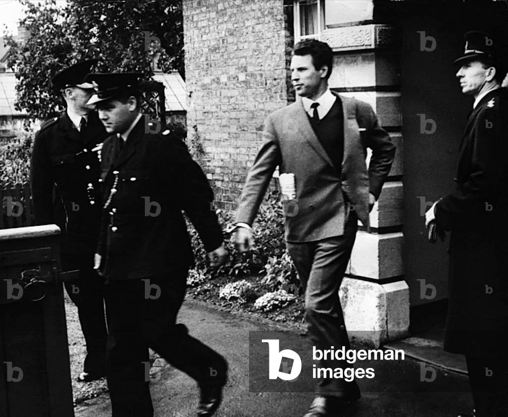 Charles Wilson Great Train Robber, handcuffed to prison officer and led away from Aylesbury Crown Court, 10th September 1963 (b/w photo)