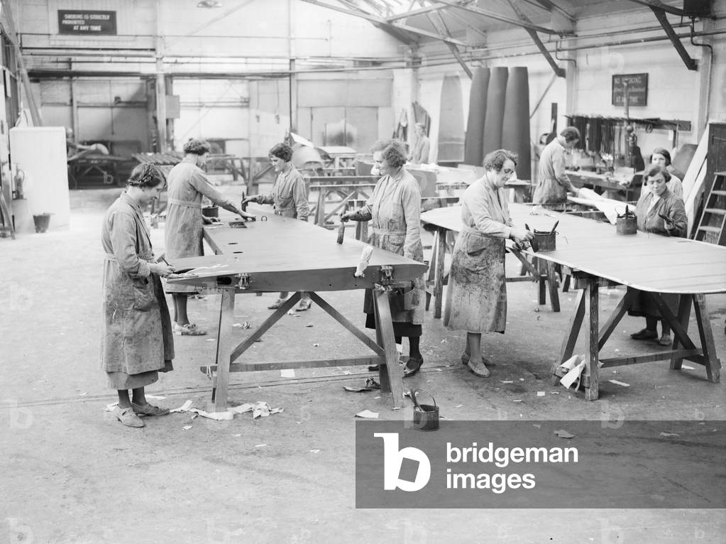 Women workers doping the wings during the construction of the Miles 3 Falcon aircraft at the Philips and Powis factory at Woodley Aerodrome, Reading 2nd April 1934 (b/w photo)
