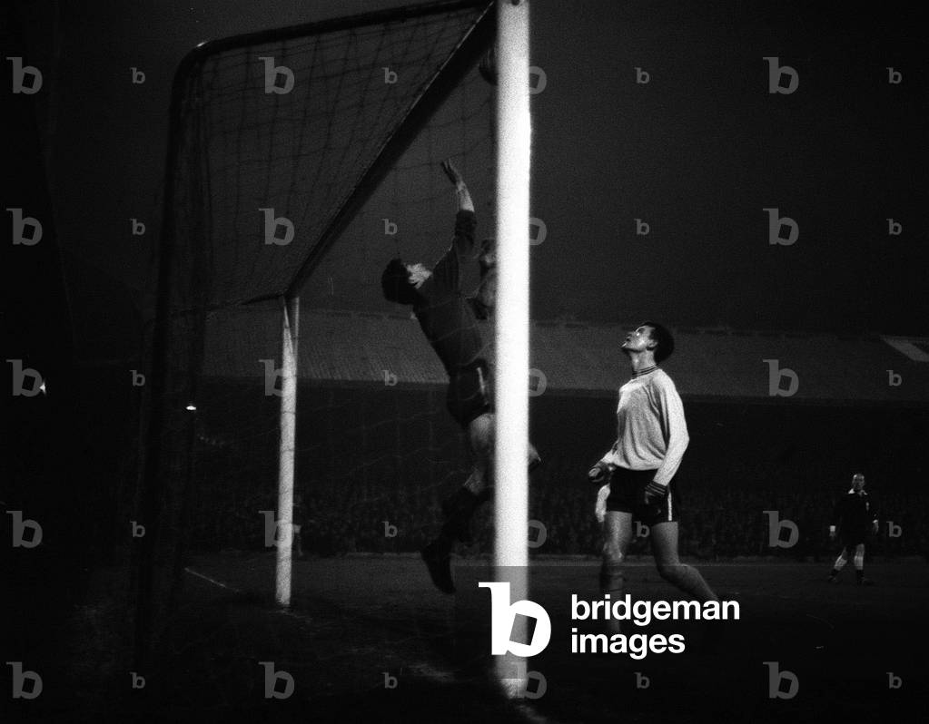 1965 League Cup Final Second leg. Chelsea goalkeeper Peter Bonnetti pushes the ball over the bar saving an almost certain goal watched by teammate Eddie McCreadie during the second leg of the Final against Leicester City. The match ended goalless with Chelsea winning 3-2 on aggregate. 5th April 1965 (photo)