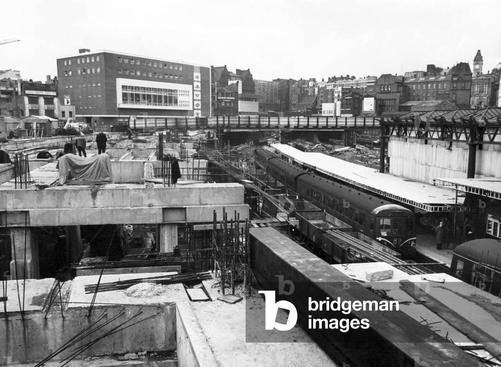 View from the temporary bridge over New Street Station looking towards the new Savoy Hotel with platform 7 on right. Birmingham, West Midlands. 16th March 1965 (b/w photo)
