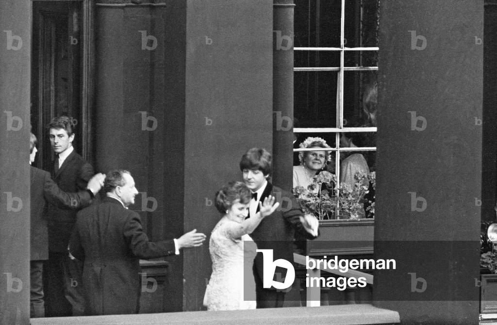 The Beatles in Liverpool for the Premier of a Hard Day's Night. Paul McCartney makes a balcony appearance and waves to cheering crowds. 10th July 1964